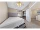 Cozy bedroom with plush carpet, a ceiling fan, and an adjacent loft area at 2416 Sun Shores Dr, Las Vegas, NV 89128