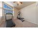 A bonus room with a treadmill, elliptical, and a large window for natural light at 2416 Sun Shores Dr, Las Vegas, NV 89128