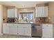 Stylish kitchen with white cabinets, granite countertops, and stainless steel appliances at 2416 Sun Shores Dr, Las Vegas, NV 89128