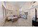 Spacious living room with tile floors, lots of natural light, and comfortable sectional sofa at 2416 Sun Shores Dr, Las Vegas, NV 89128