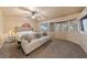 Cozy bedroom featuring a comfortable bed and sitting area with lots of windows at 2416 Sun Shores Dr, Las Vegas, NV 89128