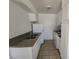 Functional kitchen featuring tile floors, white cabinets and granite-look countertops at 2513 Cedar Ave, Las Vegas, NV 89101