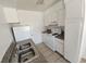 Efficient kitchen space with tile flooring, white cabinets, and ample counter space at 2513 Cedar Ave, Las Vegas, NV 89101