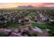 An aerial view showcases the golf course and surrounding neighborhood, enveloped in mature trees at 2528 Sunup Dr, Las Vegas, NV 89134