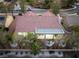 Back aerial view of home with private covered patio in landscaped backyard with palms and gravel at 2528 Sunup Dr, Las Vegas, NV 89134