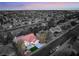 Aerial view of a residential community with a property featuring a red-tiled roof and mature landscaping at 2528 Sunup Dr, Las Vegas, NV 89134