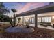 A covered patio with comfortable seating overlooks the low maintenance desert-landscaped backyard at 2528 Sunup Dr, Las Vegas, NV 89134