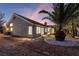 A covered patio overlooks the low maintenance desert-landscaped backyard with desert vegetation at 2528 Sunup Dr, Las Vegas, NV 89134
