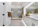 Elegant bathroom boasts a glass enclosed shower, white marble, dual sink vanity with gold fixtures, and updated lighting at 2528 Sunup Dr, Las Vegas, NV 89134