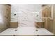 Modern glass shower with dual shower heads, marble tile and wood bench at 2528 Sunup Dr, Las Vegas, NV 89134