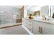 Modern bathroom featuring double vanity, a walk-in shower with marble, and elegant fixtures at 2528 Sunup Dr, Las Vegas, NV 89134