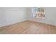 A bright bedroom featuring wood-look flooring and a view of the neighborhood from the window at 2528 Sunup Dr, Las Vegas, NV 89134