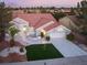 Charming single-story home with a red tile roof, well-manicured landscaping, and a two-car garage at 2528 Sunup Dr, Las Vegas, NV 89134