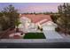 Beautiful single-story house with red tile roof, lush landscaping, and a spacious driveway at 2528 Sunup Dr, Las Vegas, NV 89134