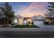 Lovely home featuring a red tile roof, a two-car garage, and a beautifully landscaped front yard at 2528 Sunup Dr, Las Vegas, NV 89134