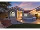 Inviting front exterior with manicured landscaping, a red tile roof, and stylish architectural details at 2528 Sunup Dr, Las Vegas, NV 89134