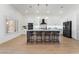 Modern kitchen island with seating, pendant lighting, and stainless steel appliances at 2528 Sunup Dr, Las Vegas, NV 89134