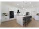 Bright kitchen featuring quartz countertops, modern appliances, and ample cabinet space at 2528 Sunup Dr, Las Vegas, NV 89134