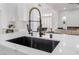Close-up of modern kitchen island with black sink and gold faucet fixtures at 2528 Sunup Dr, Las Vegas, NV 89134