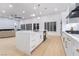 Open-concept kitchen featuring a large island and stainless steel appliances and gold hardware at 2528 Sunup Dr, Las Vegas, NV 89134