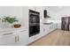 Elegant white kitchen with stainless steel appliances and modern gold hardware at 2528 Sunup Dr, Las Vegas, NV 89134