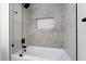 A contemporary shower with gray tiling, glass enclosure, and a built-in shelving niche at 2528 Sunup Dr, Las Vegas, NV 89134