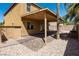 This backyard includes a covered patio and is surrounded by gravel and lush landscaping at 2608 Los Palos St, Las Vegas, NV 89108