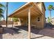 This backyard features a covered patio and gravel surround with palm tree landscaping at 2608 Los Palos St, Las Vegas, NV 89108