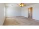 Spacious bedroom featuring neutral carpet, a ceiling fan, and an attached laundry room at 2608 Los Palos St, Las Vegas, NV 89108