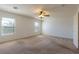 Bright bedroom showcasing neutral carpet, two windows with natural light, and a ceiling fan at 2608 Los Palos St, Las Vegas, NV 89108