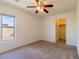 Well-lit bedroom with neutral walls, ceiling fan, and closet access at 2608 Los Palos St, Las Vegas, NV 89108