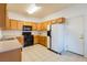 Functional kitchen featuring ample wood cabinets and white appliances at 2608 Los Palos St, Las Vegas, NV 89108