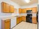 Kitchen features wood cabinets, lots of counter space and black appliances at 2608 Los Palos St, Las Vegas, NV 89108