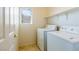 Practical laundry room with washer, dryer, and convenient shelving at 2608 Los Palos St, Las Vegas, NV 89108