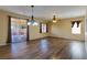 Open-concept living room with wood-look floors, sliding door to patio, and lots of natural light at 2608 Los Palos St, Las Vegas, NV 89108