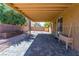 Covered patio with brick flooring offers an outdoor living space with lush landscaping at 2608 Los Palos St, Las Vegas, NV 89108