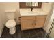 Bathroom features a white toilet, vanity with black fixtures, and black tile floor at 2615 W Gary Ave # 1015, Las Vegas, NV 89123