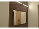 Modern bathroom with a slat wall, vanity, and a decorative mirror at 2615 W Gary Ave # 1015, Las Vegas, NV 89123