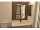 Well-lit bathroom showcases a vanity with black faucet and decorative mirror on slat wall at 2615 W Gary Ave # 1015, Las Vegas, NV 89123