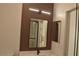 Modern bathroom with a slat wall, vanity, and a decorative mirror at 2615 W Gary Ave # 1015, Las Vegas, NV 89123