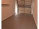 Attached garage with painted floor and storage shelf at 2615 W Gary Ave # 1015, Las Vegas, NV 89123