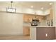 A bright kitchen is featured with modern stainless steel appliances and wood cabinets at 2615 W Gary Ave # 1015, Las Vegas, NV 89123