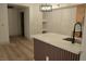 An open kitchen features a stainless steel sink, modern pendant lighting, and quartz countertops at 2615 W Gary Ave # 1015, Las Vegas, NV 89123