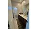 Bathroom featuring double sinks with modern dark cabinets and a shower/tub combination at 3216 Waterstone Ave, Henderson, NV 89044