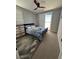 Cozy bedroom featuring a ceiling fan, neutral walls, and a sliding glass door leading to outdoor views at 3216 Waterstone Ave, Henderson, NV 89044
