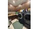 Functional laundry room with ample cabinet space, modern appliances, and tile flooring at 3216 Waterstone Ave, Henderson, NV 89044