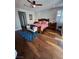 A primary bedroom showcasing hardwood floors, ceiling fan, an upholstered bench and stylish decor at 3216 Waterstone Ave, Henderson, NV 89044