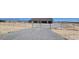 Wide angle of the property showing a chain-link fence, landscaping, and the home's facade at 3761 S Tumbleweed Ave, Pahrump, NV 89048