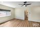 This bedroom features wood floors, neutral walls, and a modern ceiling fan at 3761 S Tumbleweed Ave, Pahrump, NV 89048