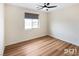 This bedroom features wood floors, neutral walls, and a modern ceiling fan at 3761 S Tumbleweed Ave, Pahrump, NV 89048